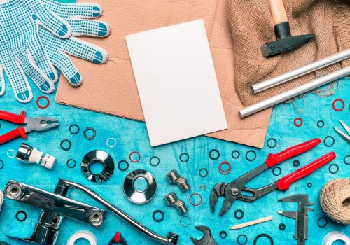 Plumbing tools and blank notebook mock up, top view flat lay