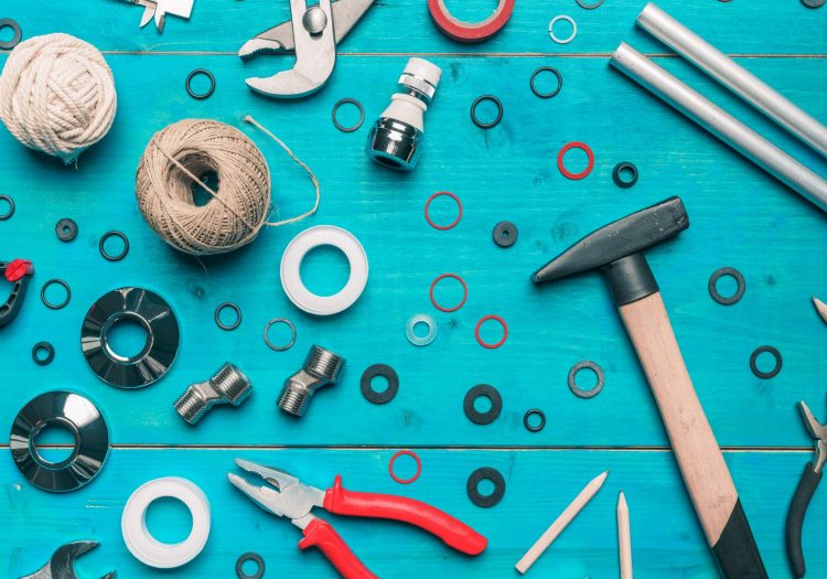 Plumbing toolset flat lay top view on blue wooden background